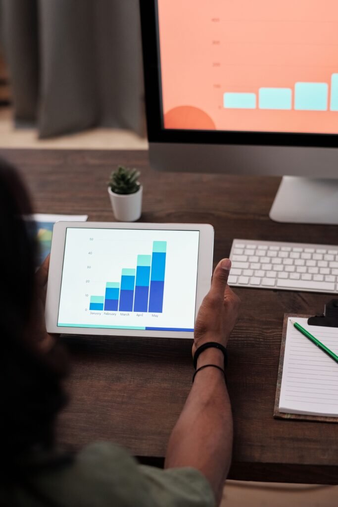 Businesswoman analyzing graphs on tablet
